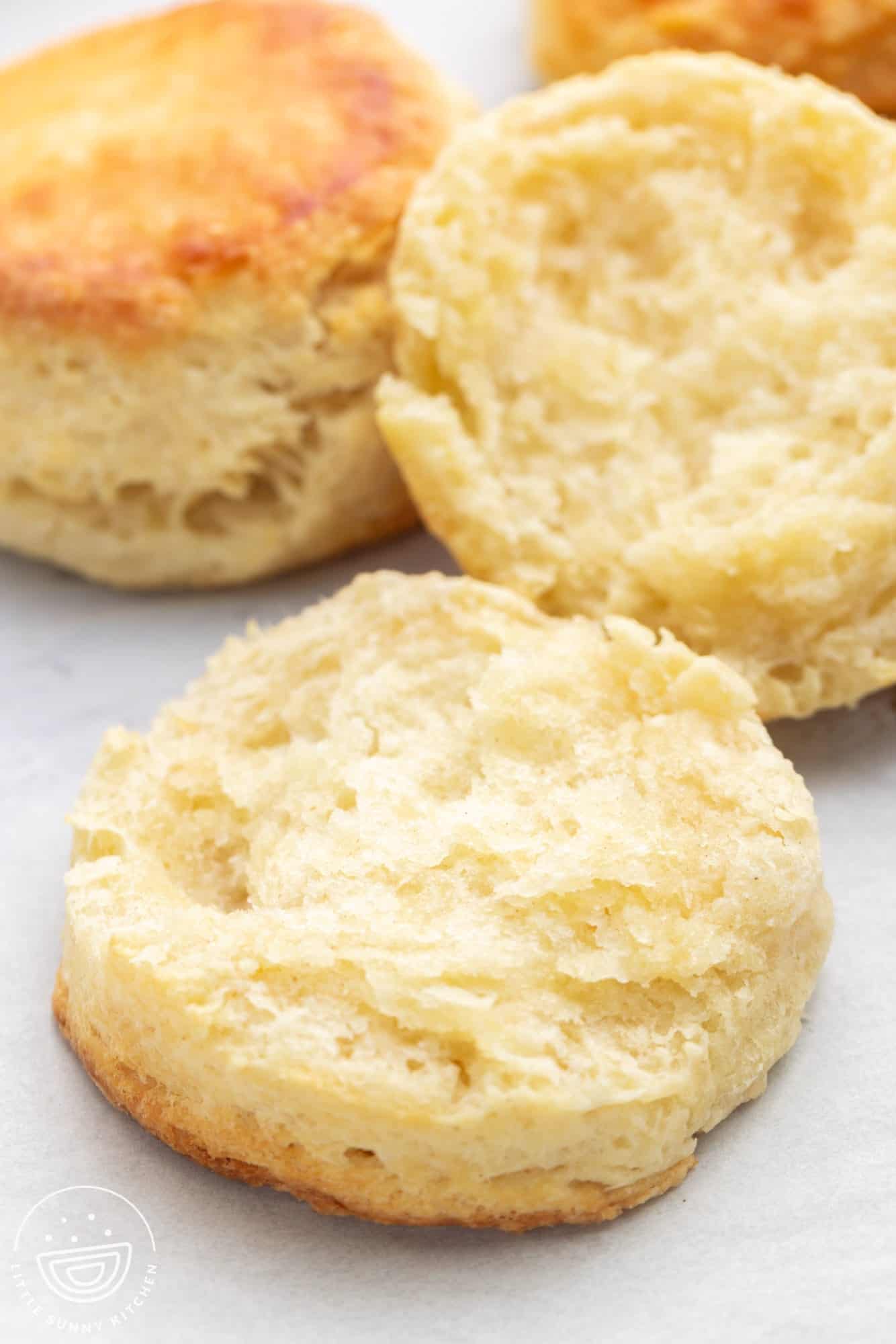 a split fluffy buttermilk biscuit on a counter.