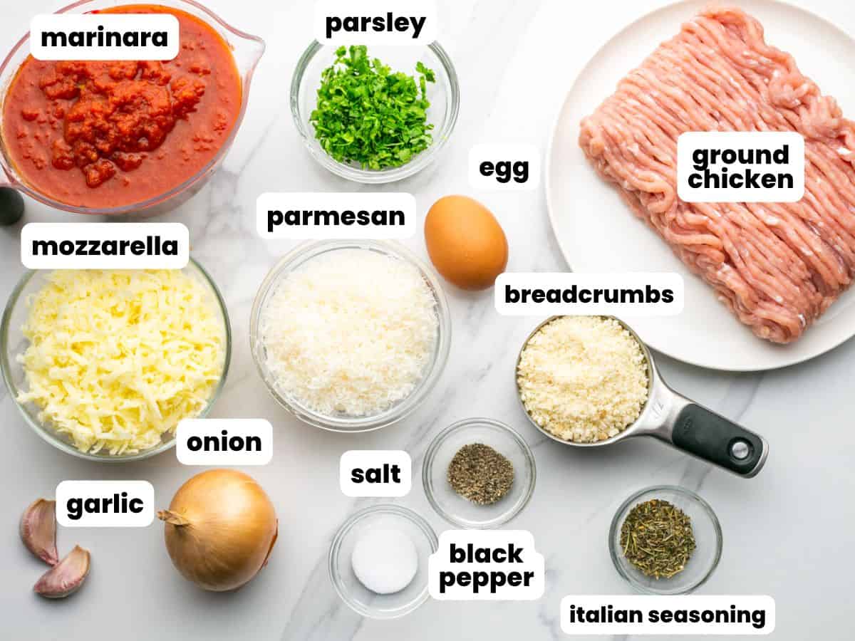 The ingredients needed to make chicken parm meatballs, including ground chicken and cheese.