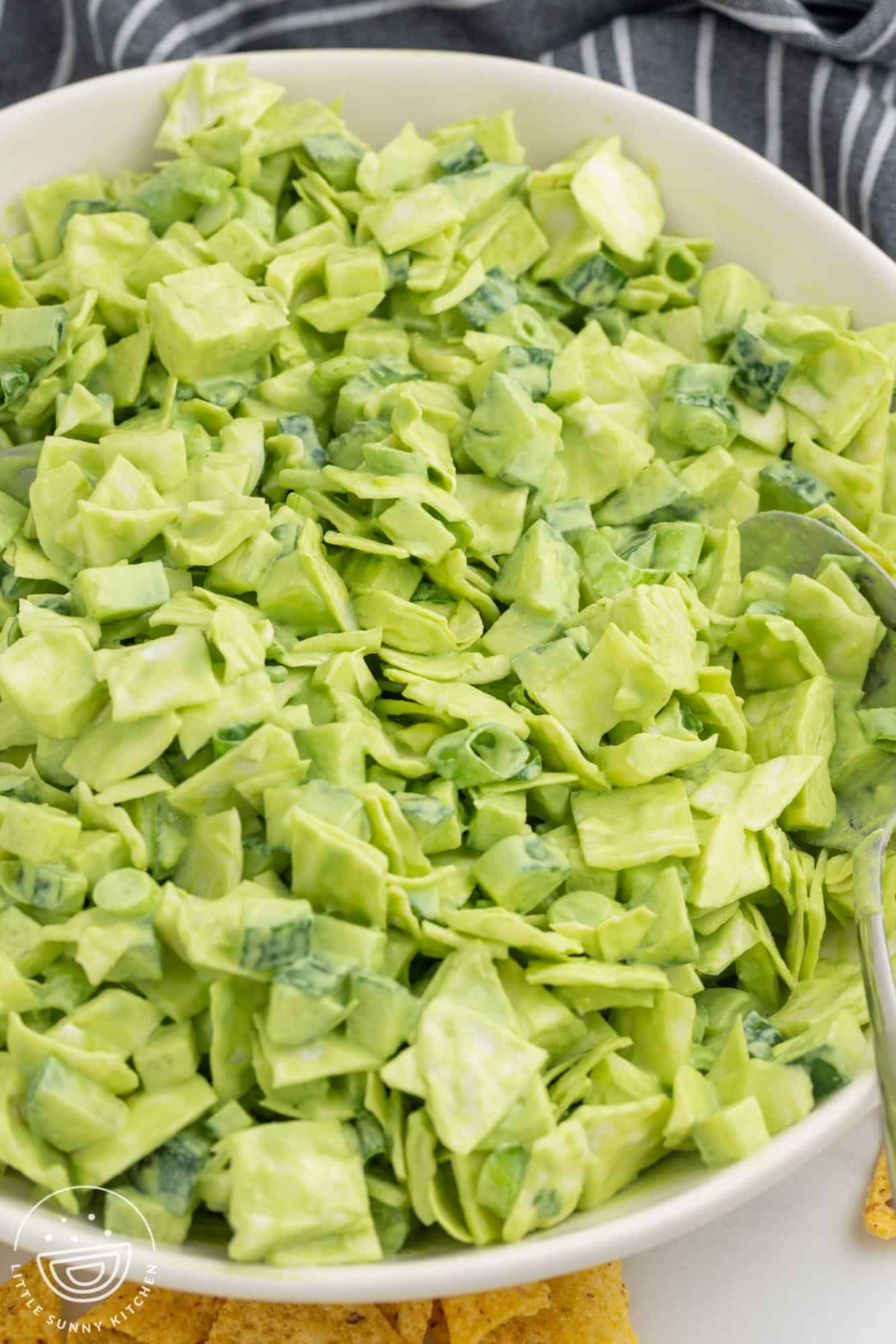 Angle shot of green goddess salad in a large white bowl