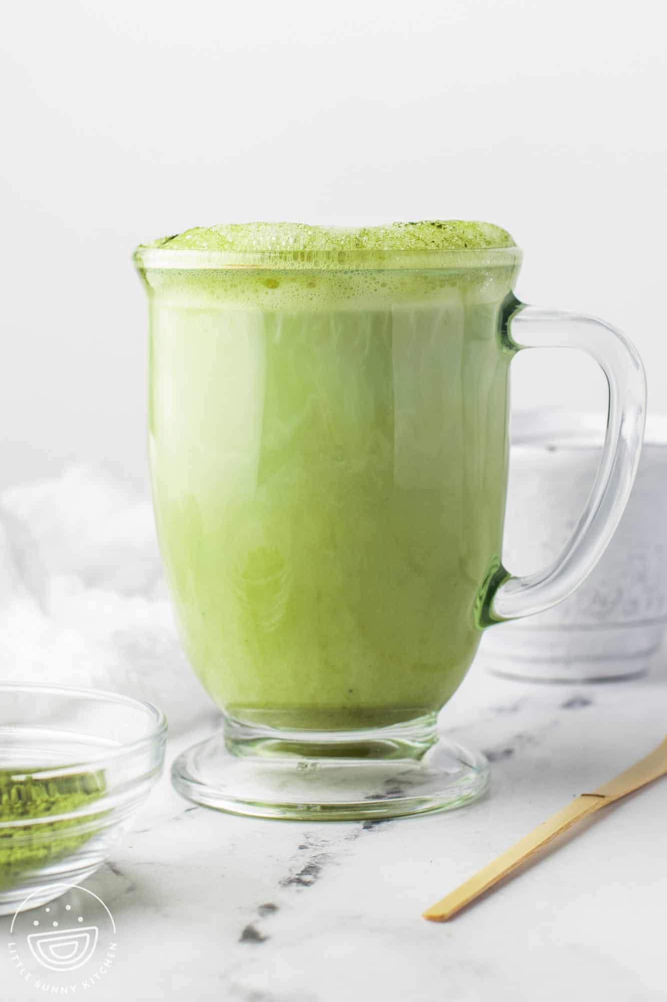 Perfect cup of matcha latte, in a glass mug.