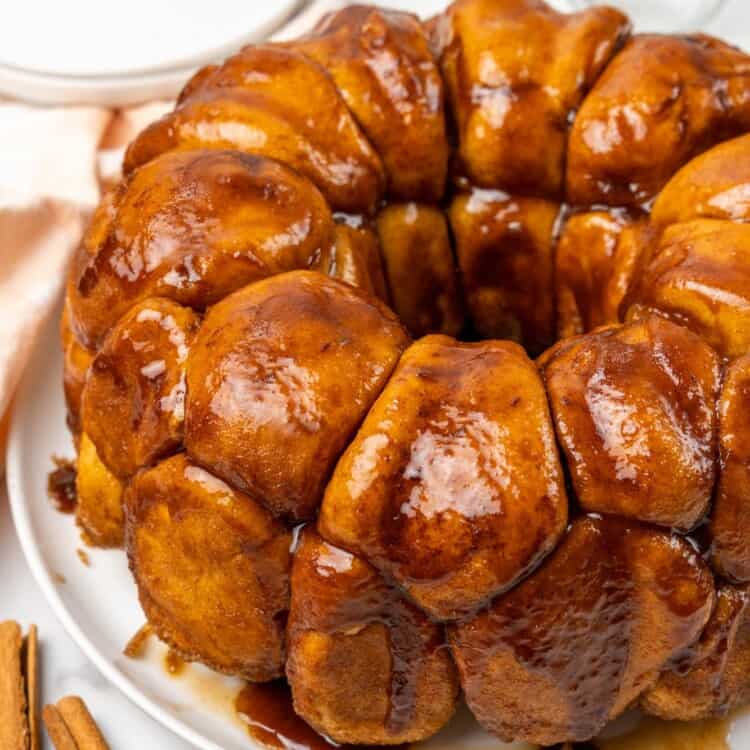 Monkey bread served on a white plate, made in a bundt pan.