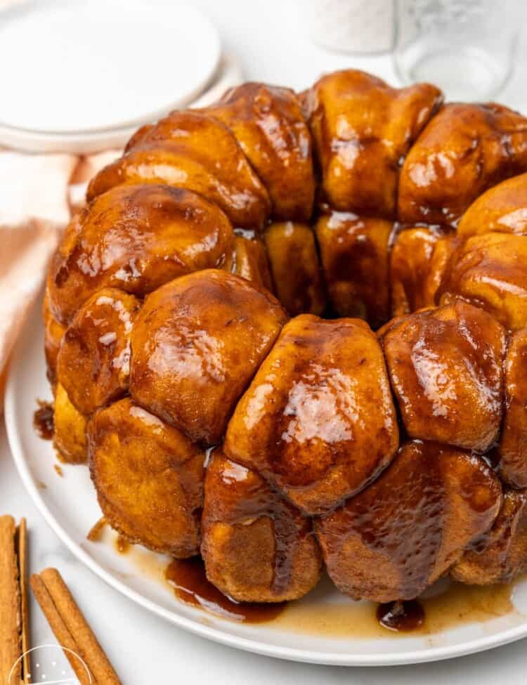 Monkey bread served on a white plate, made in a bundt pan.