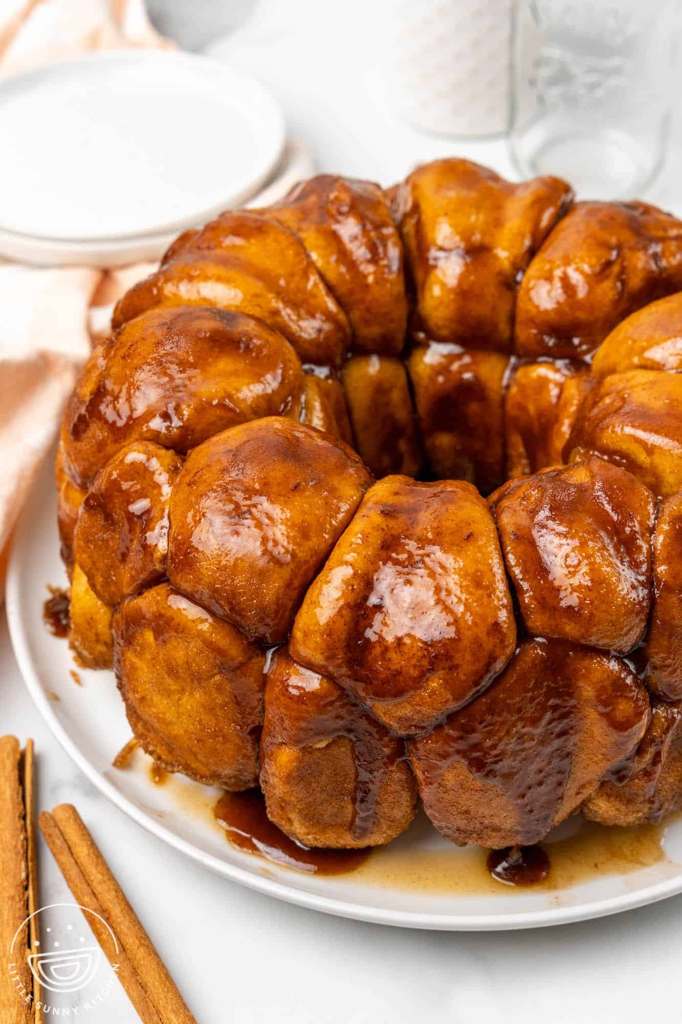 Monkey bread served on a white plate, made in a bundt pan.