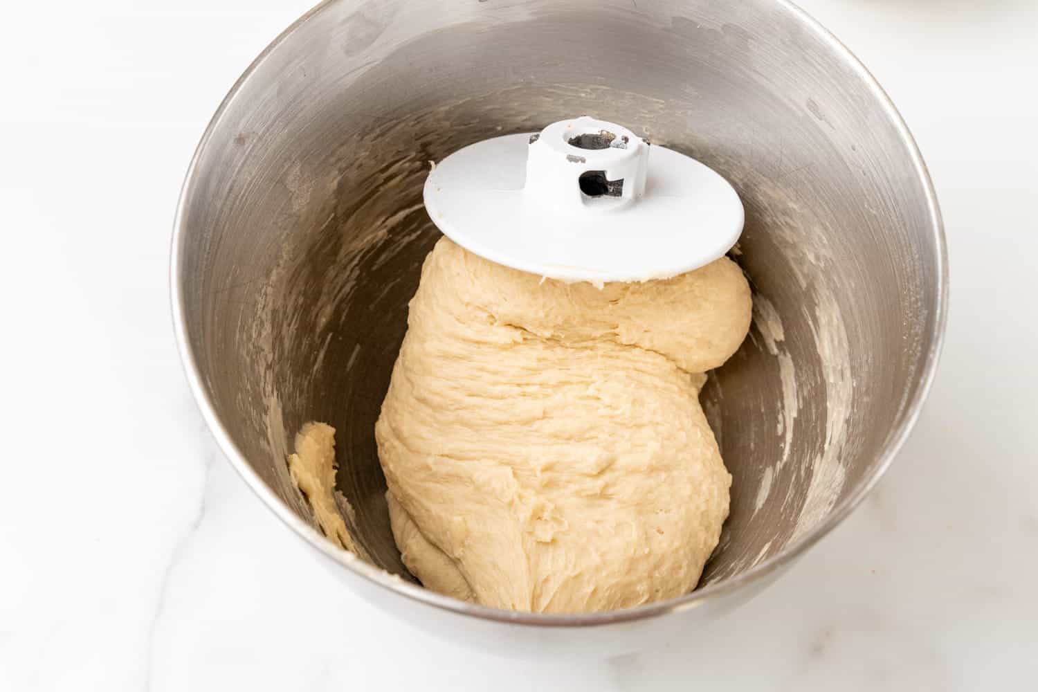 Kneaded dough in a metal bowl with the dough attachment