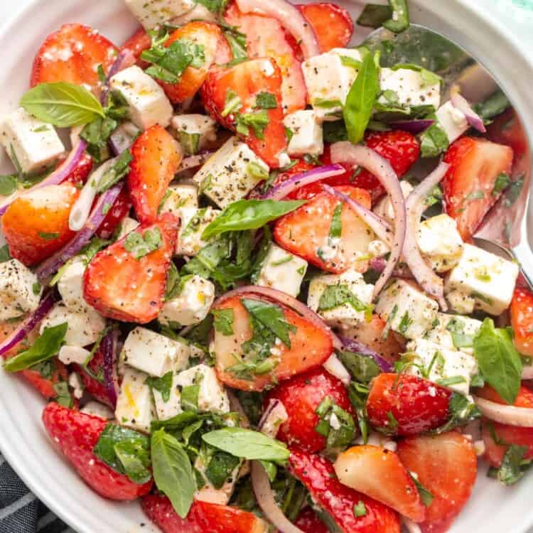 Overhead shot of strawberry feta salad in a white bowl