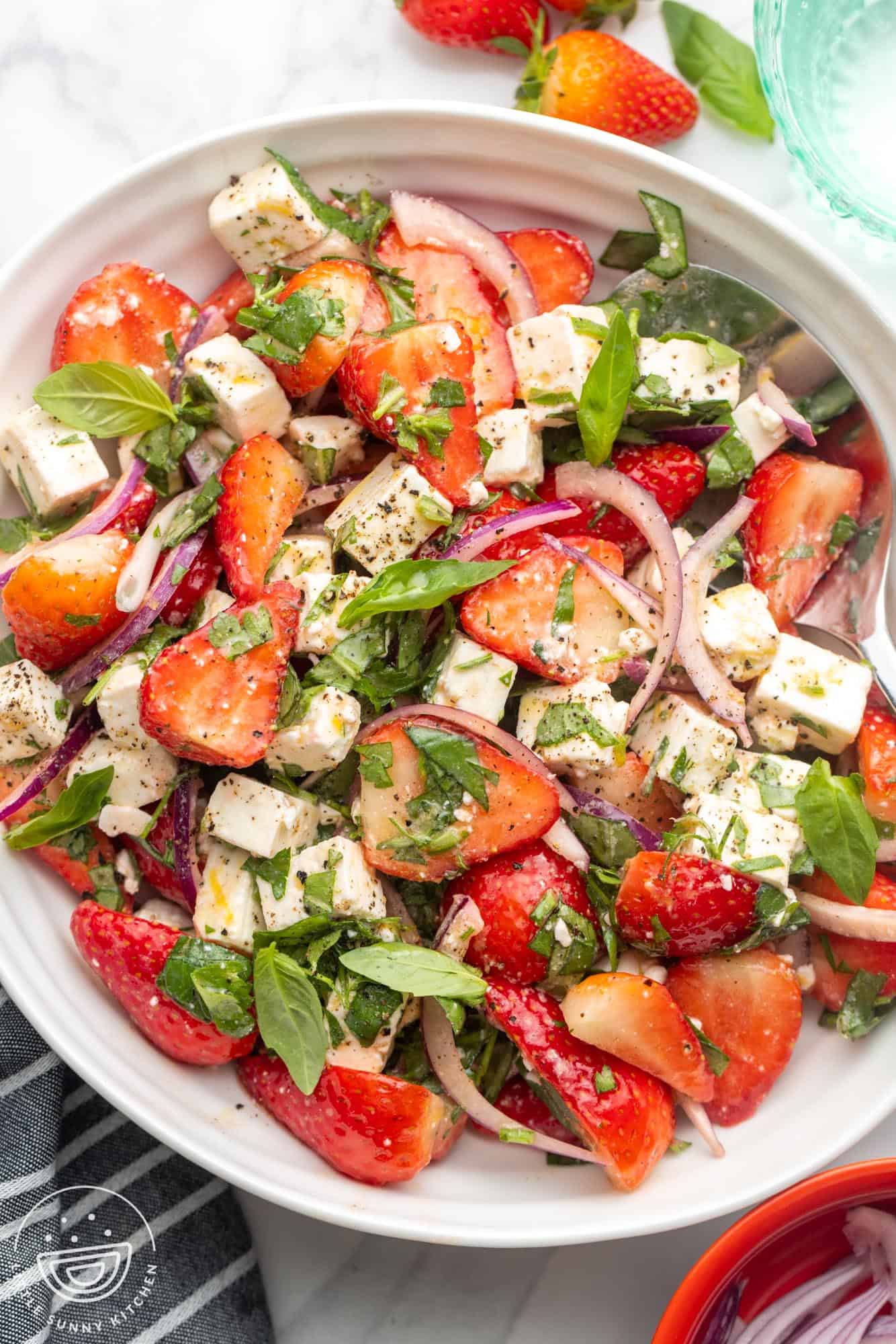 Overhead shot of strawberry feta salad in a white bowl