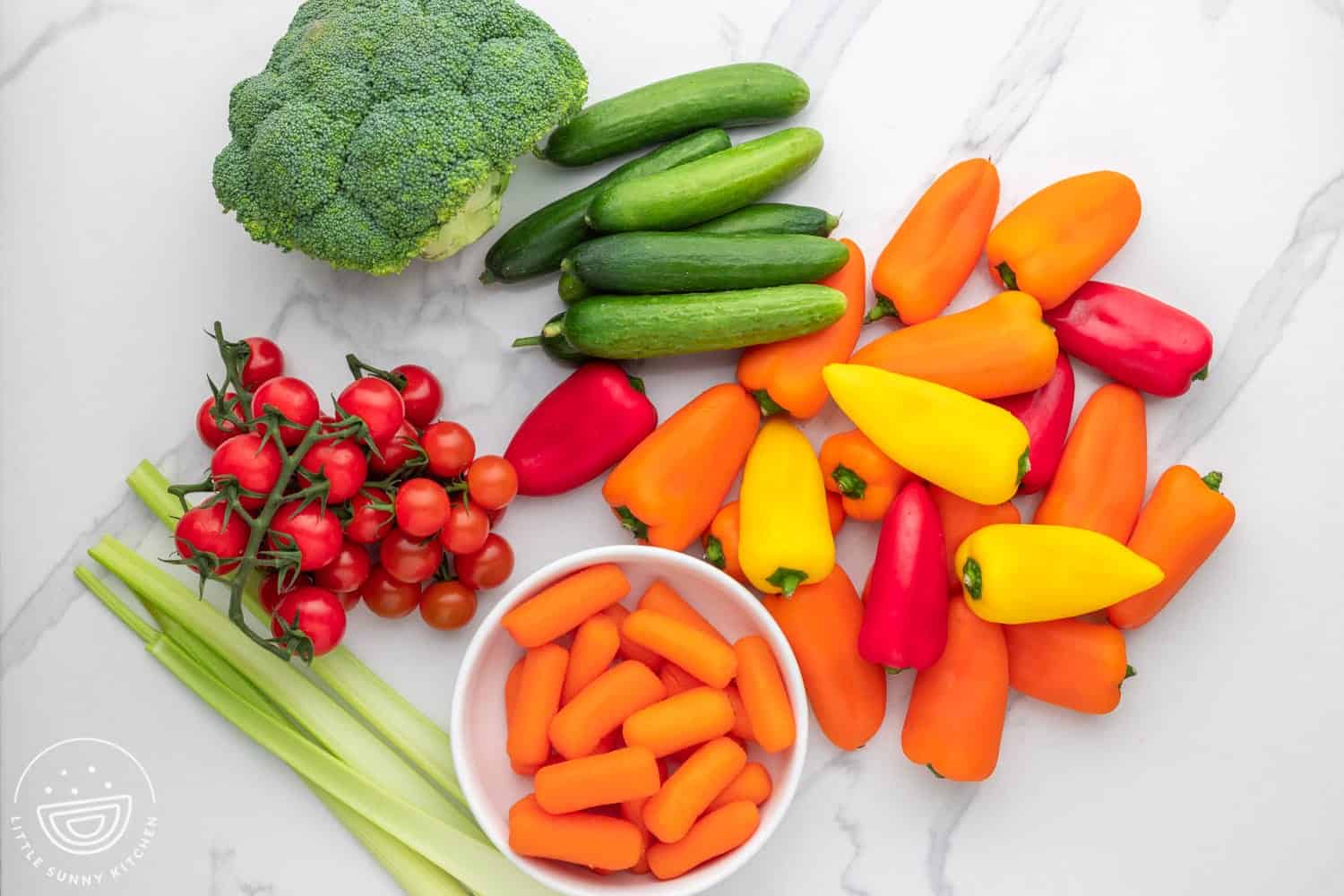 The ingredients needed to make a colorful veggie dip platter.