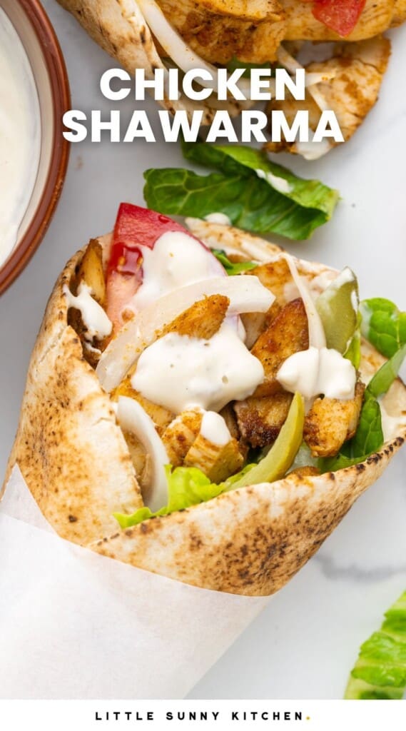 chicken shawarma in a wrap with onions, lettuce, and tomato. Text overlay says "chicken shawarma"