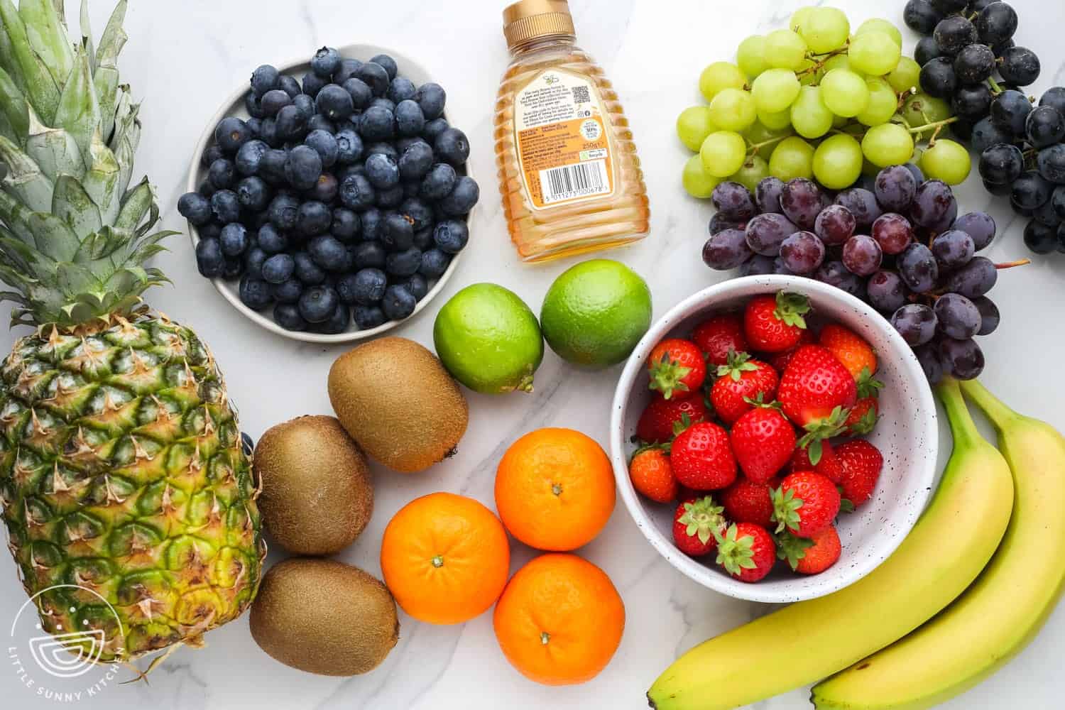 Ingredients needed to make a fruit salad with honey lime dressing