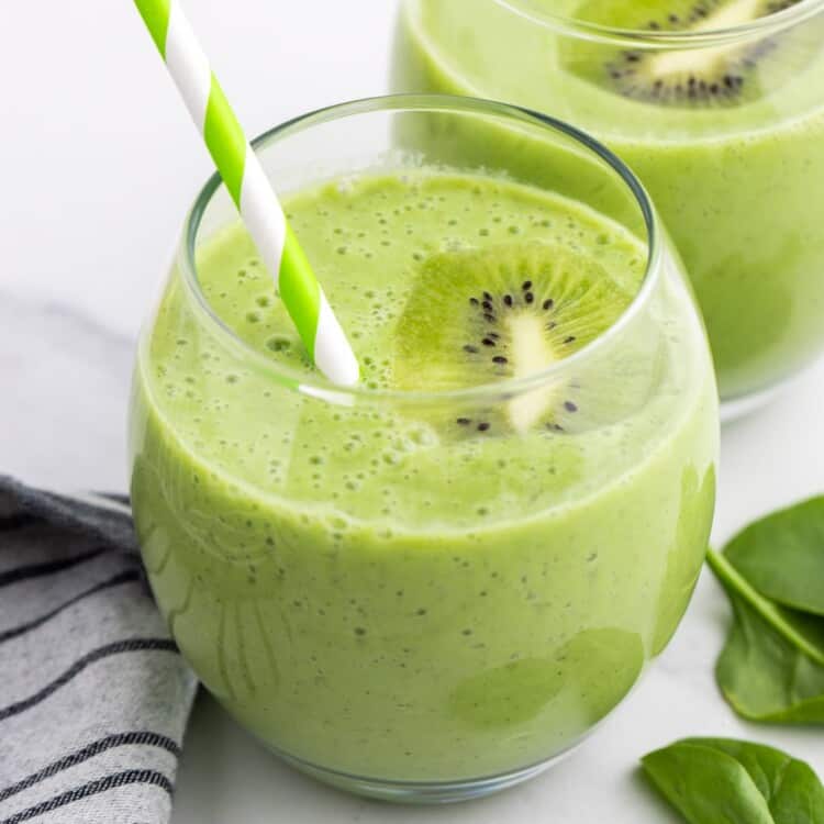 2 glasses of vibrant green kiwi smoothies, with green straws