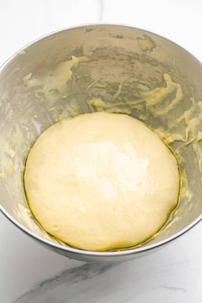Oiled dough in a bowl of a stand mixer before resting