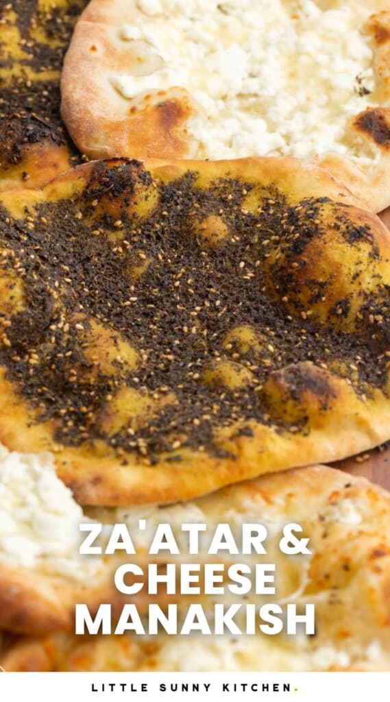 Overhead shot of zaatar and cheese manakish on a wooden board. With overlay text that says "Za'atar & Cheese Manakish"