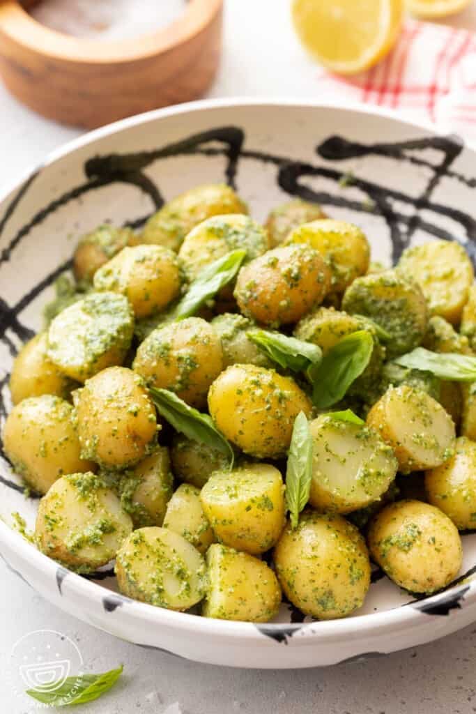 Pesto potato salad in a white and black bowl