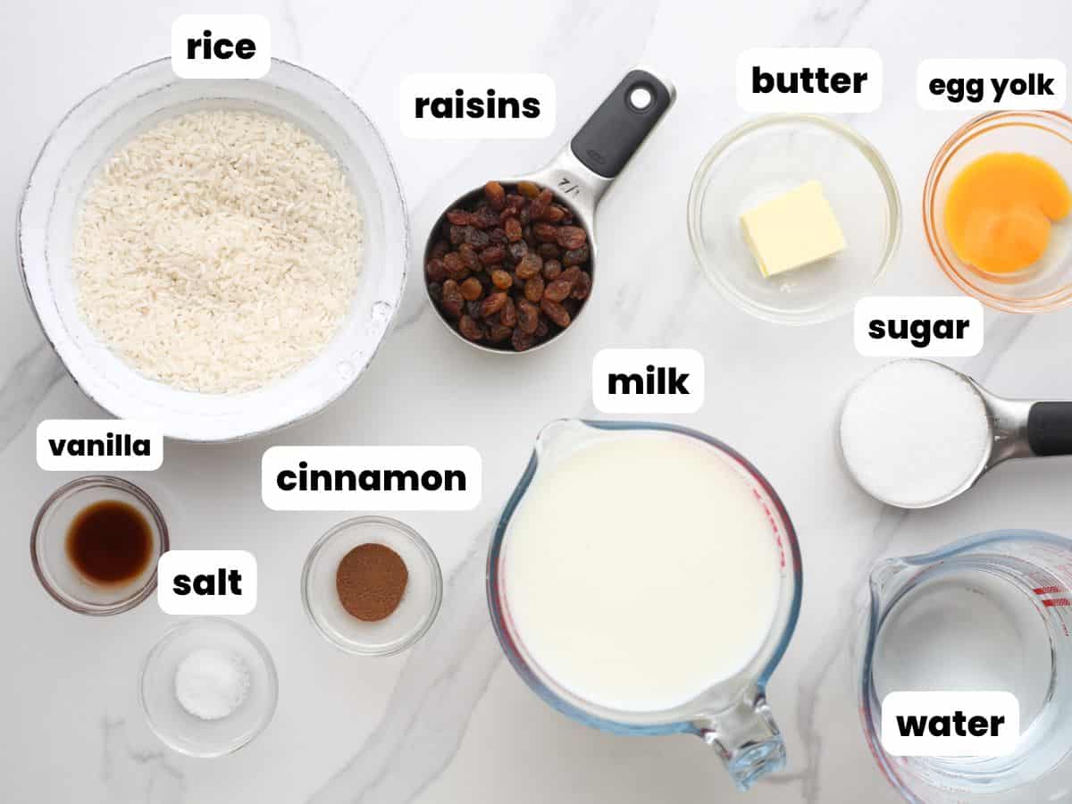 the ingredients in old fashioned rice pudding, measured into small bowls and arranged on a counter. Each is labeled with a text box.