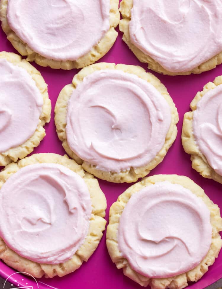 a hot pink plate filled with swig sugar cookies