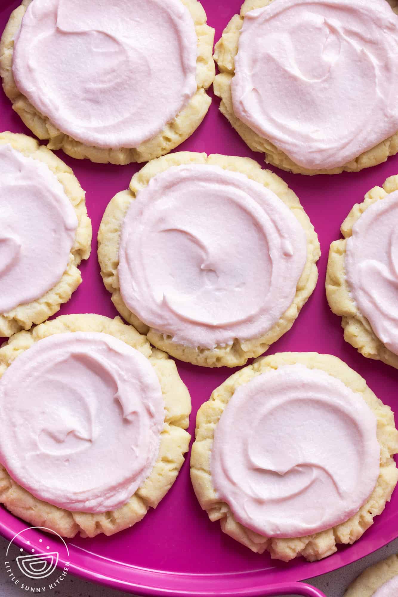 a hot pink plate filled with swig sugar cookies