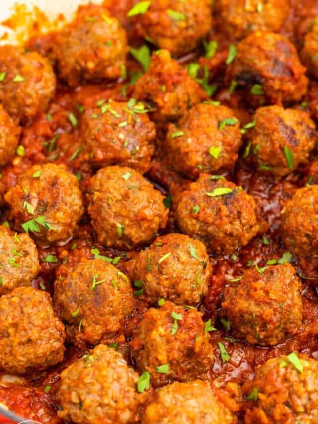 beef meatballs in a pan with tomato sauce