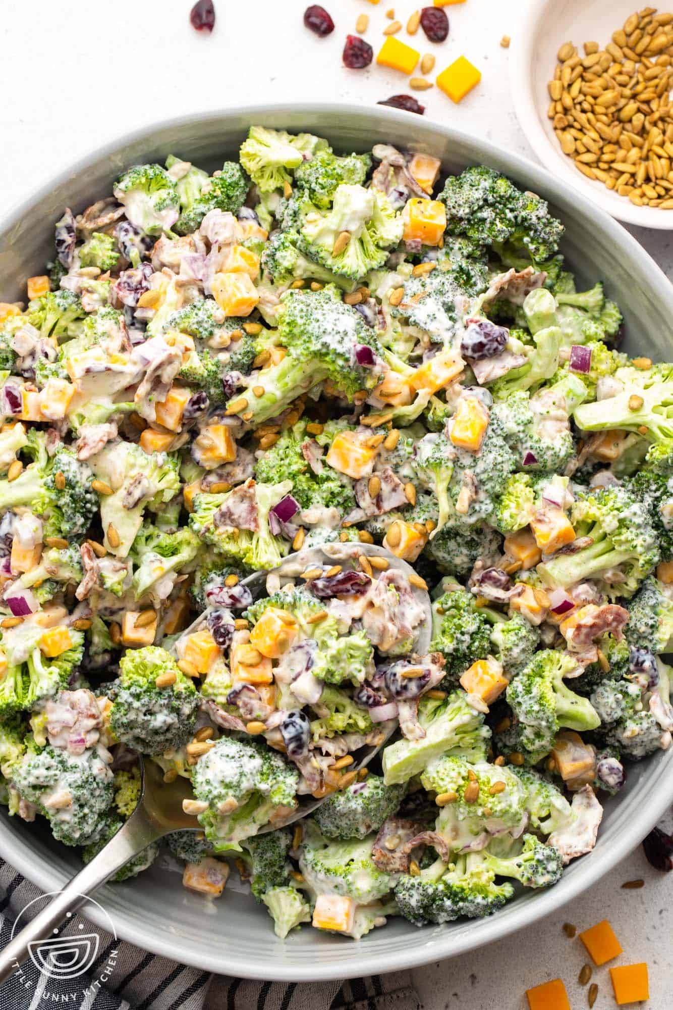 a large serving bowl of creamy broccoli salad, viewed from above.
