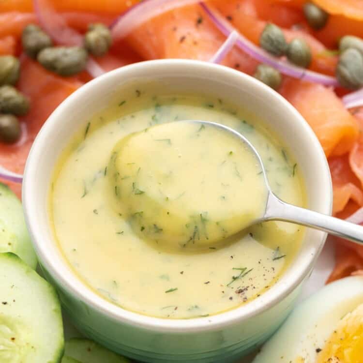 Creamy dill mustard sauce in a small bowl with a spoon