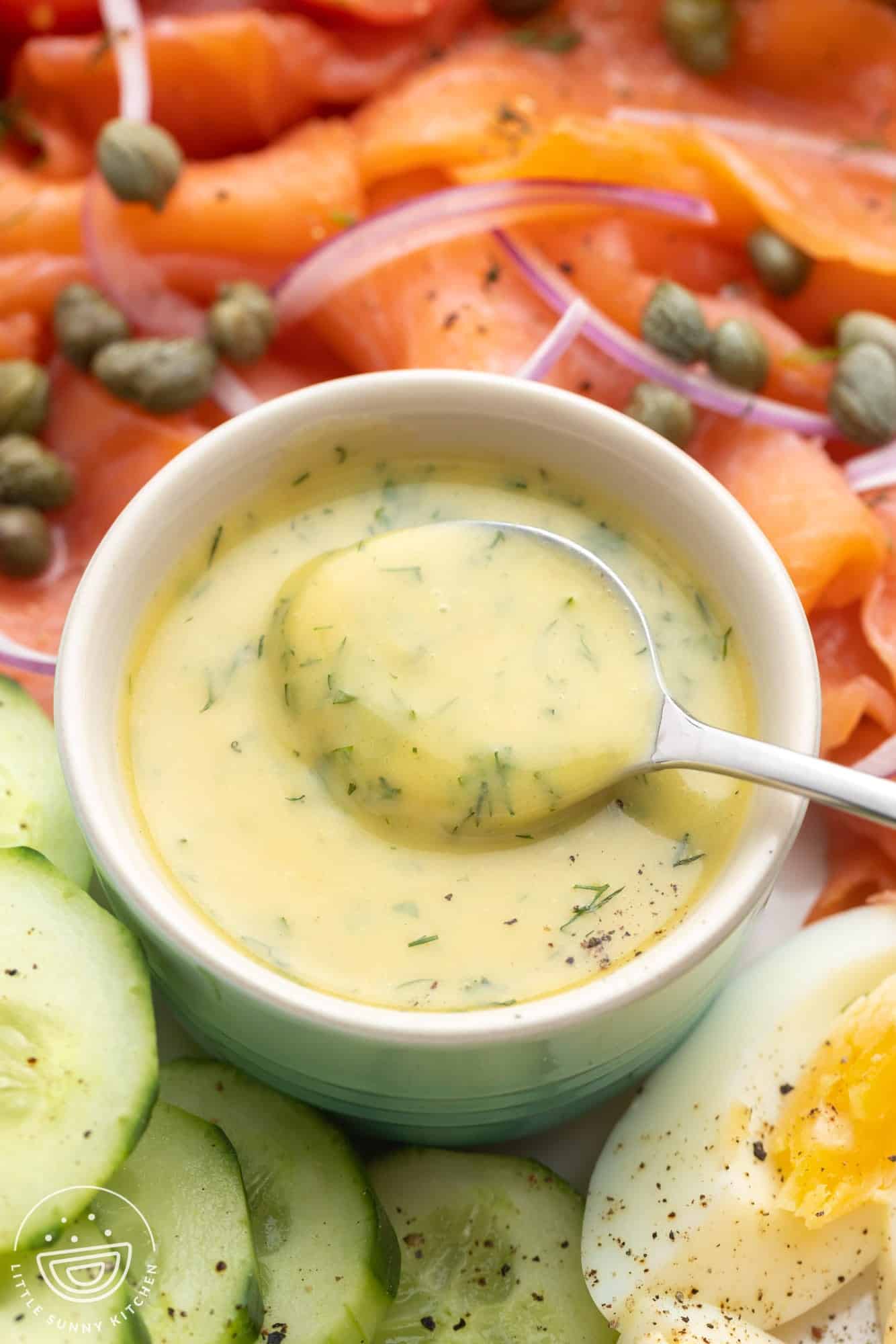 Creamy dill mustard sauce in a small bowl with a spoon