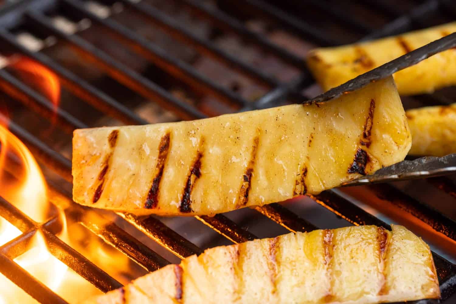 Grilled pineapple spears on the grill