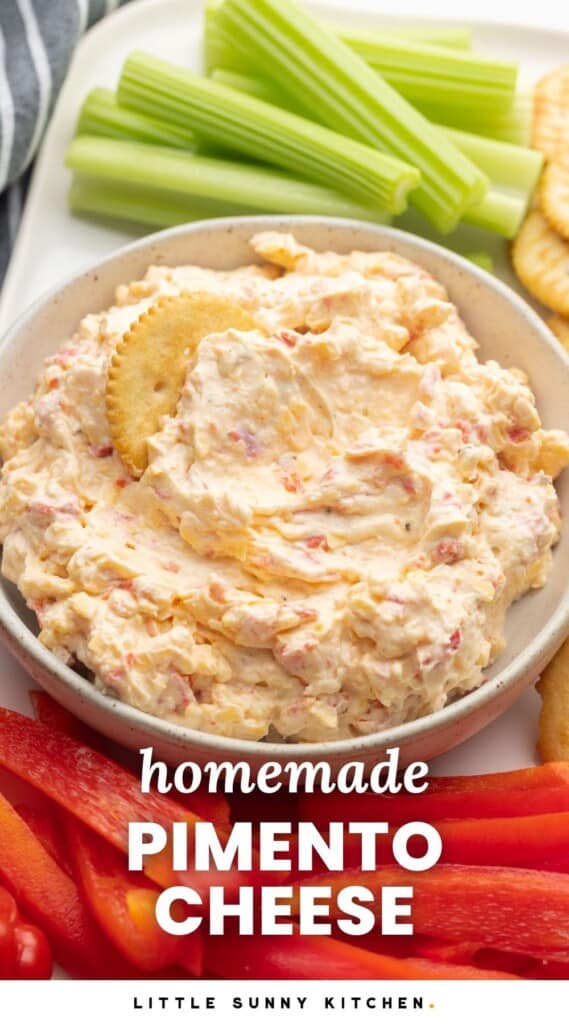 a bowl of creamy pimento cheese with a cracker in it. Text overlay says "homemade pimento cheese"