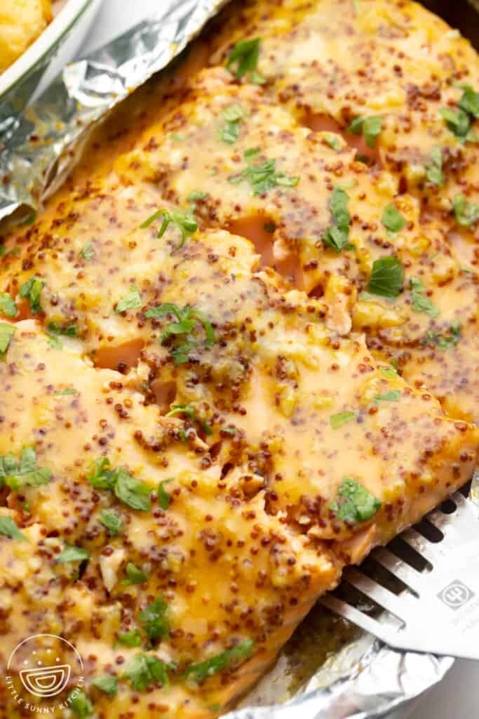 salmon wrapped in foil, topped with honey mustard.