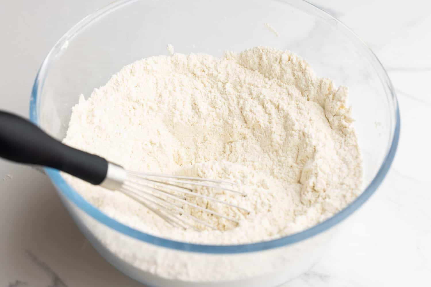 homemade pancake mix, whisked together in a clear glass mixing bowl.