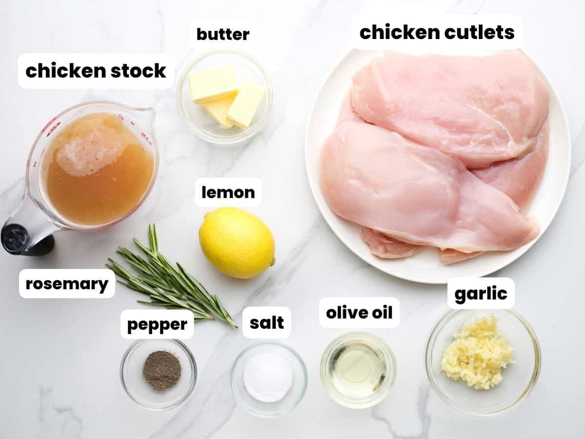 The ingredients needed to make lemon rosemary chicken with breast cutlets and fresh herbs.