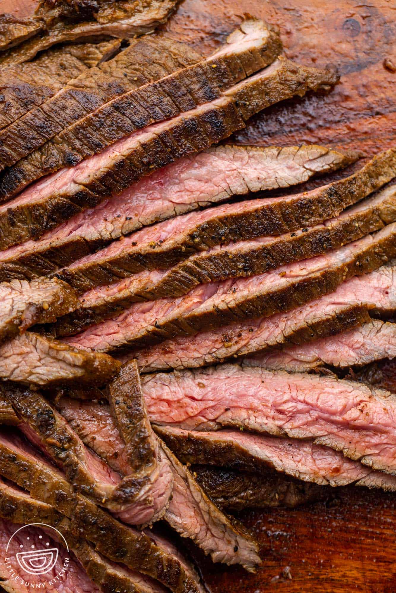 closeup of seared and sliced flank steak for fajitas, cooked medium.