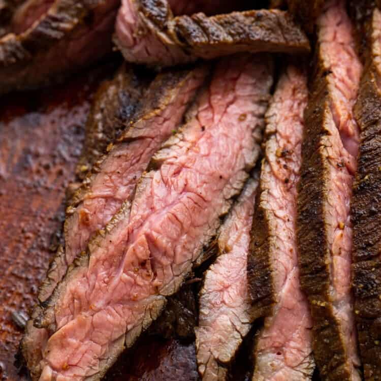 Closeup of cooked marinated flank steak, sliced thinly for steak fajitas