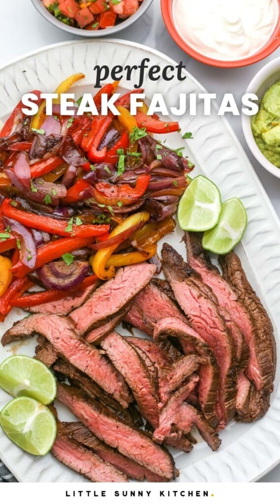 A platter of thinly sliced steak and sauteed peppers and onions. Text overlay says "perfect steak fajitas"