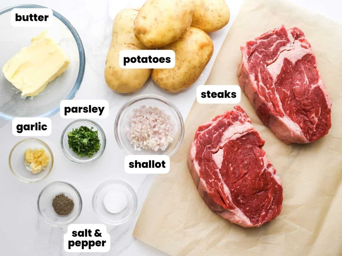 The ingredients needed to make steak frites, including thick steaks and fresh potatoes.