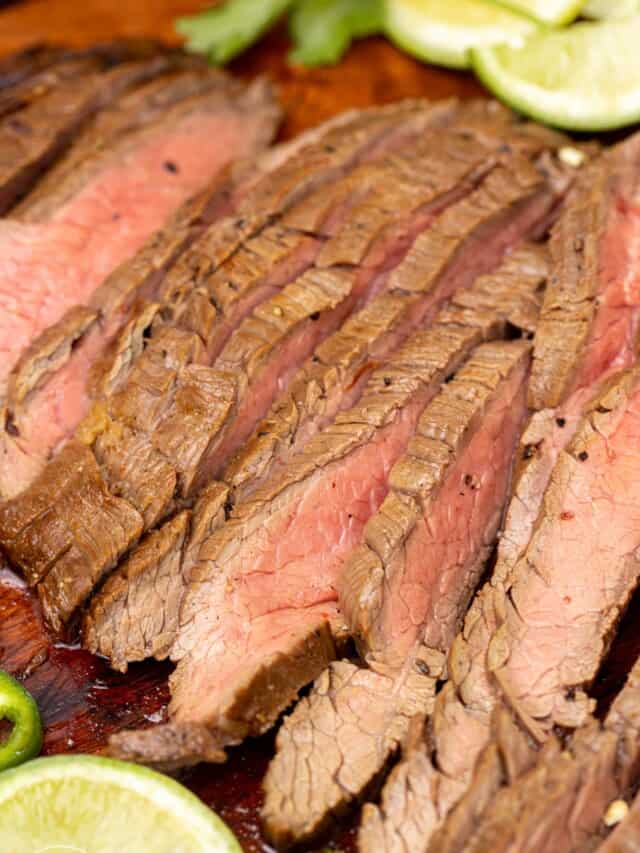 closeup view of grilled and sliced carne asada steak, it's done medium well.