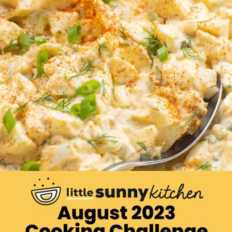 Egg salad with a spoon, and an overlay text that says "August 2023 Cooking Challenge"