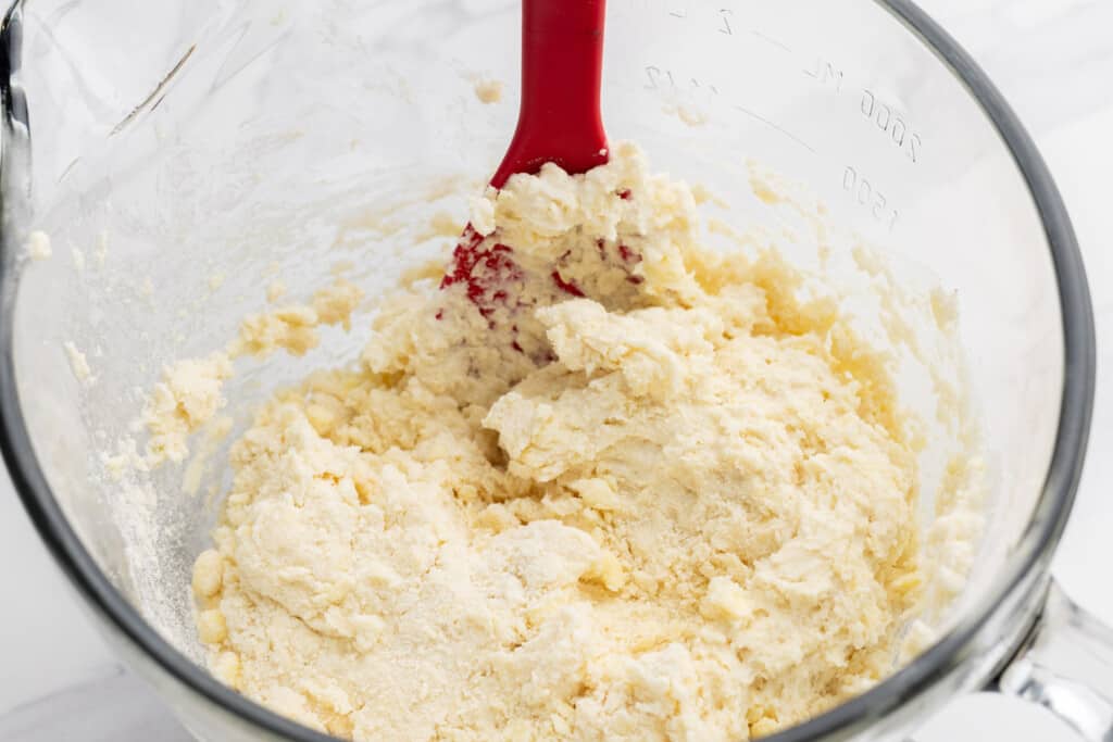 Biscuit dough in a glass bowl with a spatula