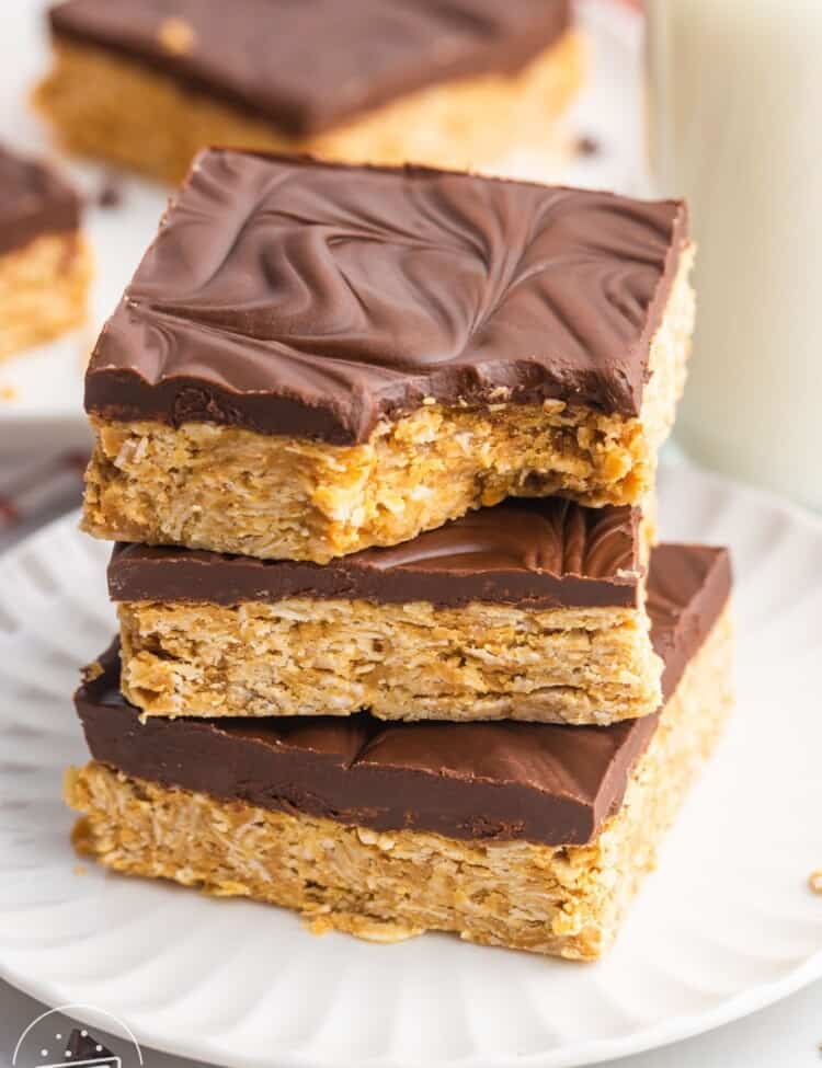three chocolate peanut butter oatmeal bars stacked on a plate.