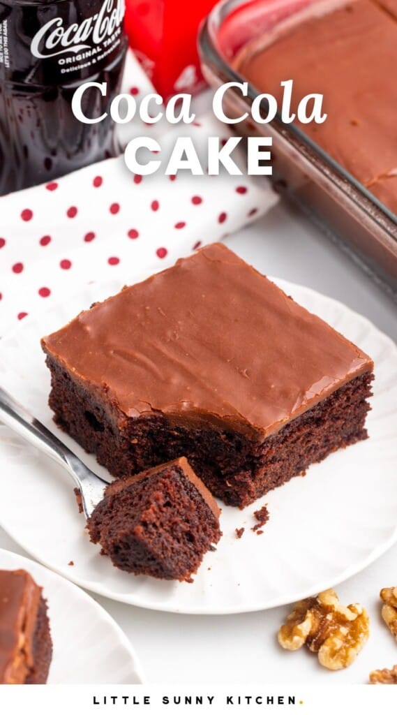 a square of cocoa cola cake with frosting on a plate. Text overlay says "coca cola cake"