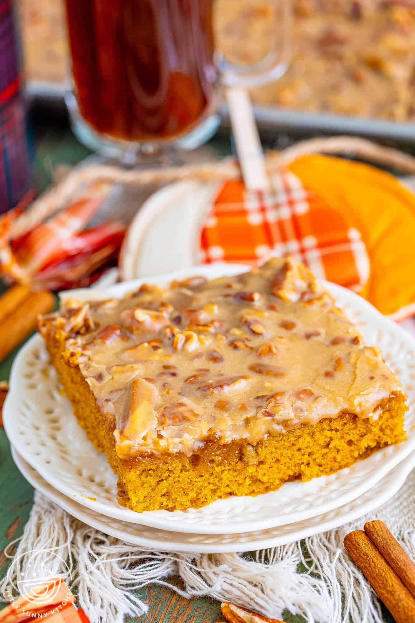 a square of pumpkin sheet cake with praline frosting on a plate.