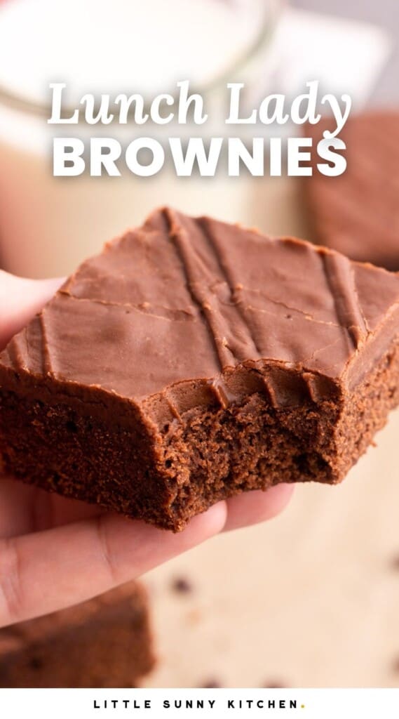a chocolate frosted brownie with a bite taken. Text overlay says "lunch lady brownies"