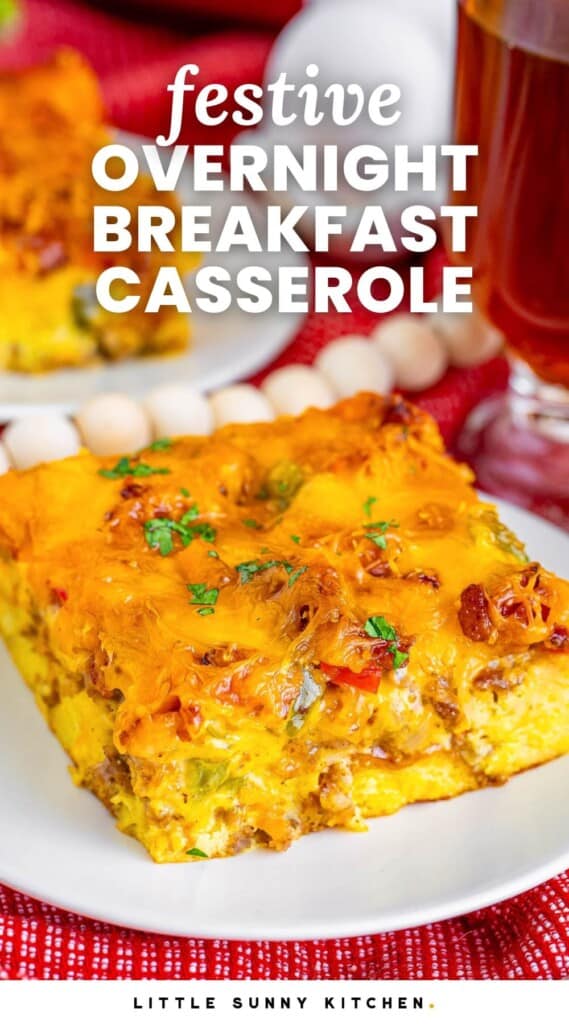 a square slice of breakfast casserole on a plate. text overlay says "festive overnight breakfast casserole"