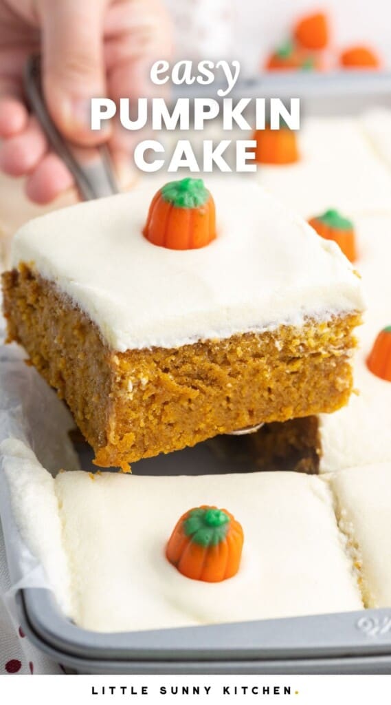 a hand picking up a slice of frosted cake with a pumpkin on it. Text overlay says "easy pumpkin cake"