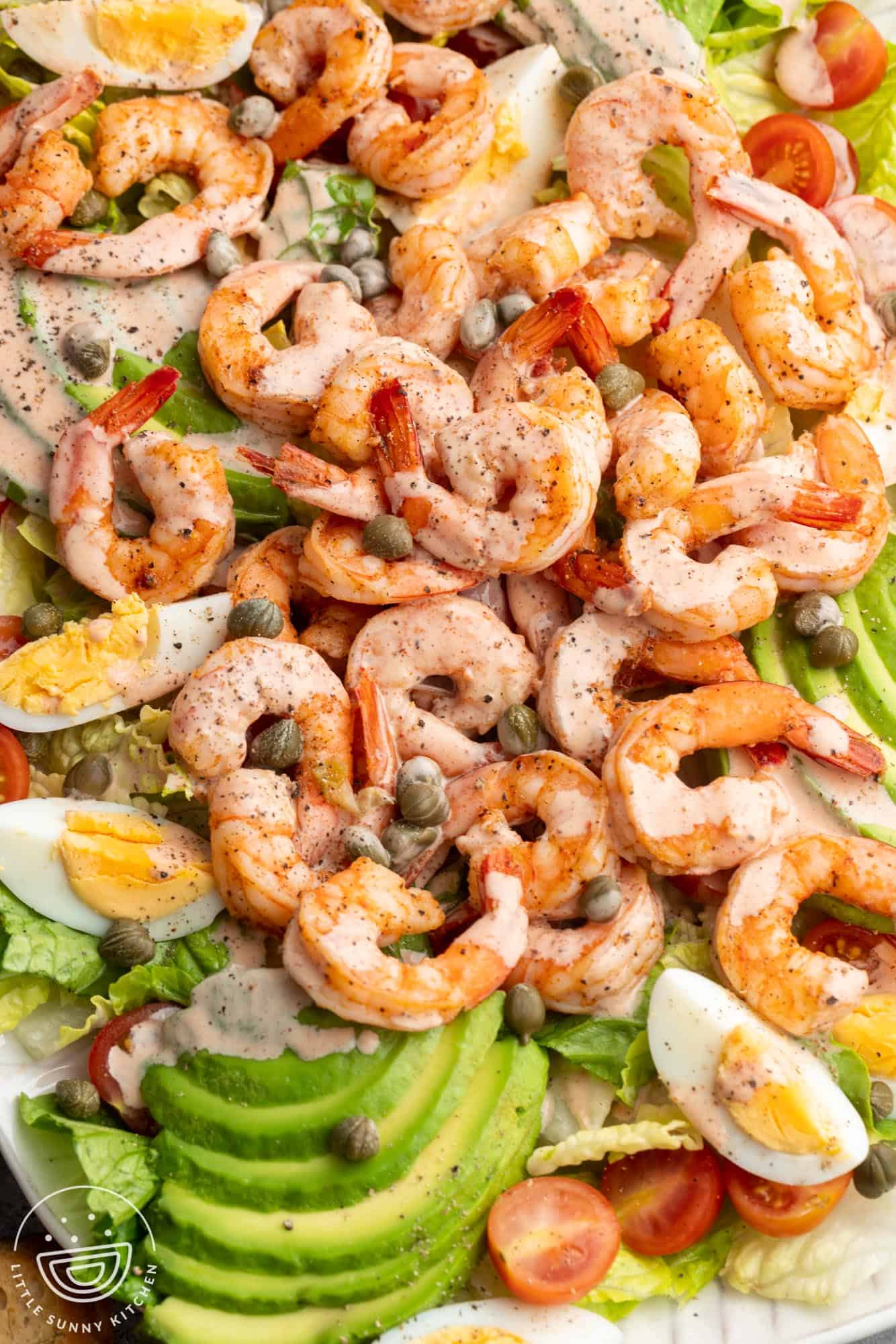 freshly made shrimp louie salad with capers and dressing.