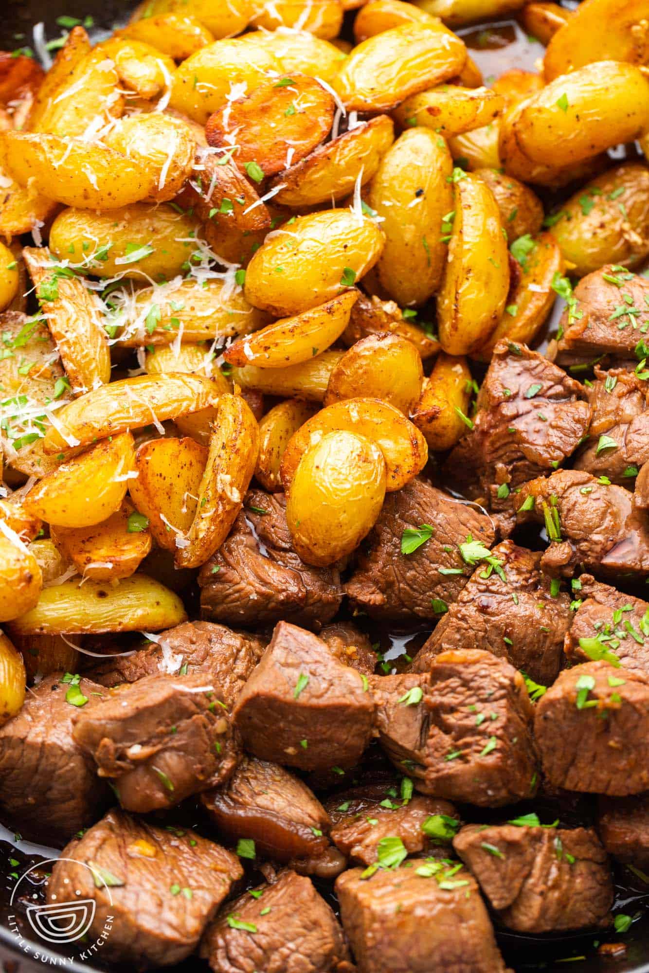 closeup of pan seared steak bites and sauteed baby potatoes.