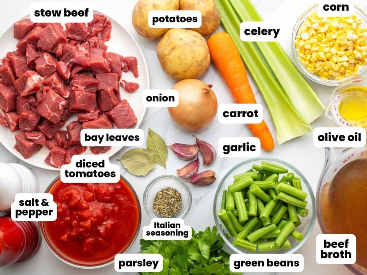 The ingredients needed to make homemade vegetable beef soup, measured and arranged on a counter.
