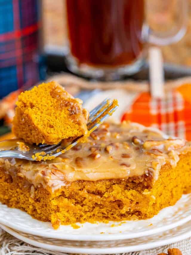 a serving of pumpkin sheet cake. A fork has taken a bite.
