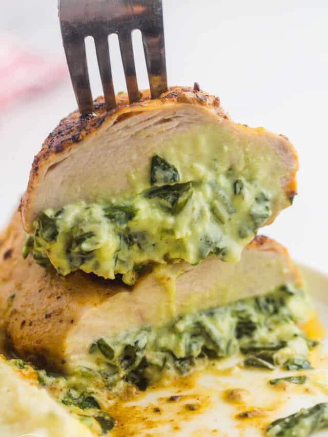 Sliced spinach and cheese stuffed chicken breasts showing the melted filling inside the chicken breast