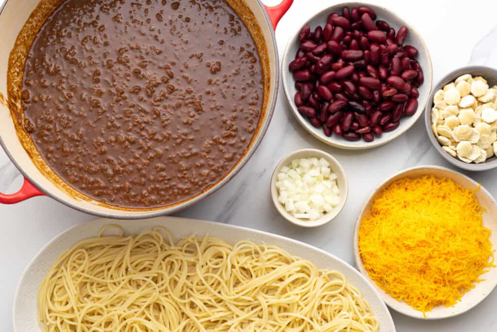 The ingredients needed to assemble a plate of cincinnati chili spaghetti