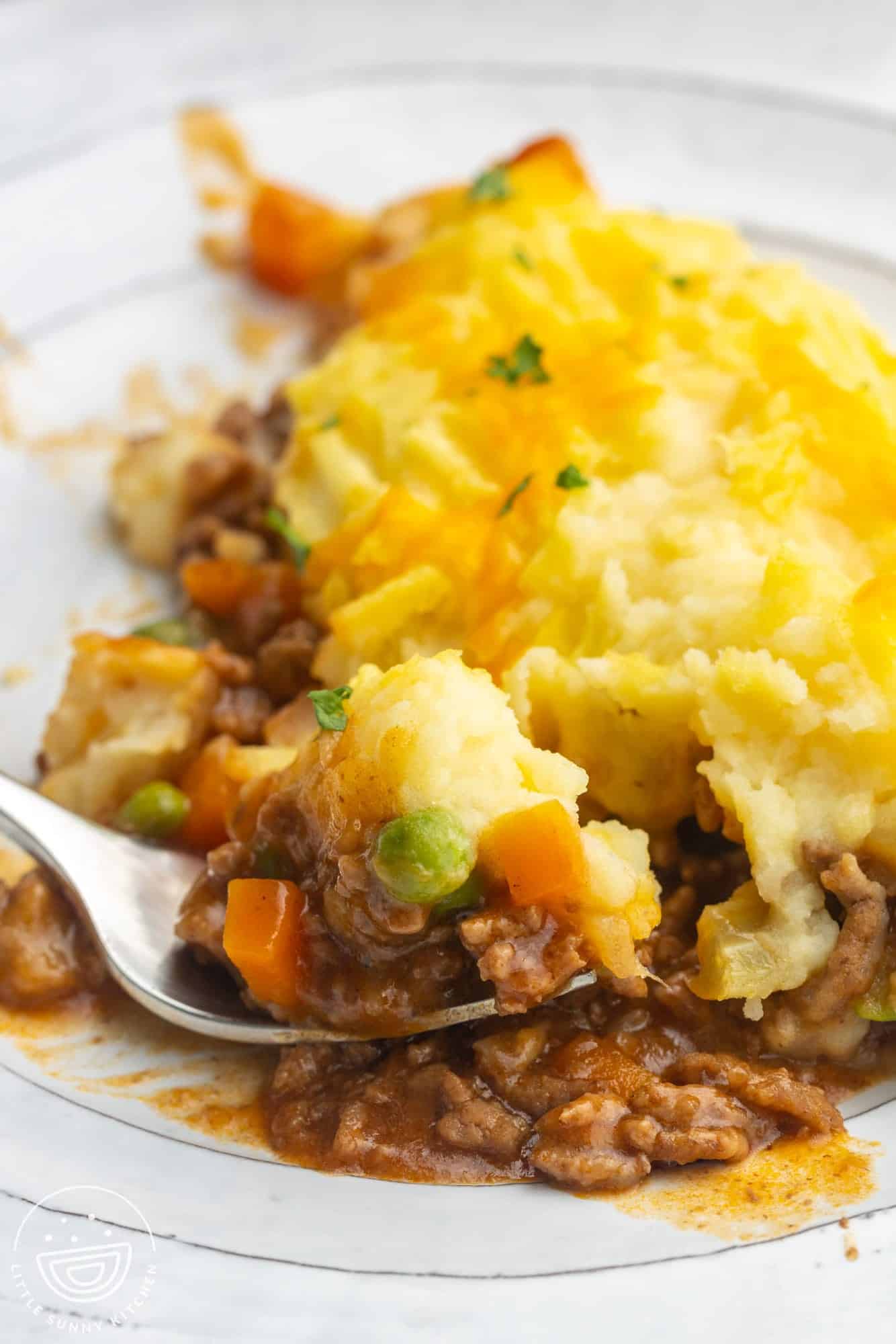 a fork eating a serving of cottage pie.