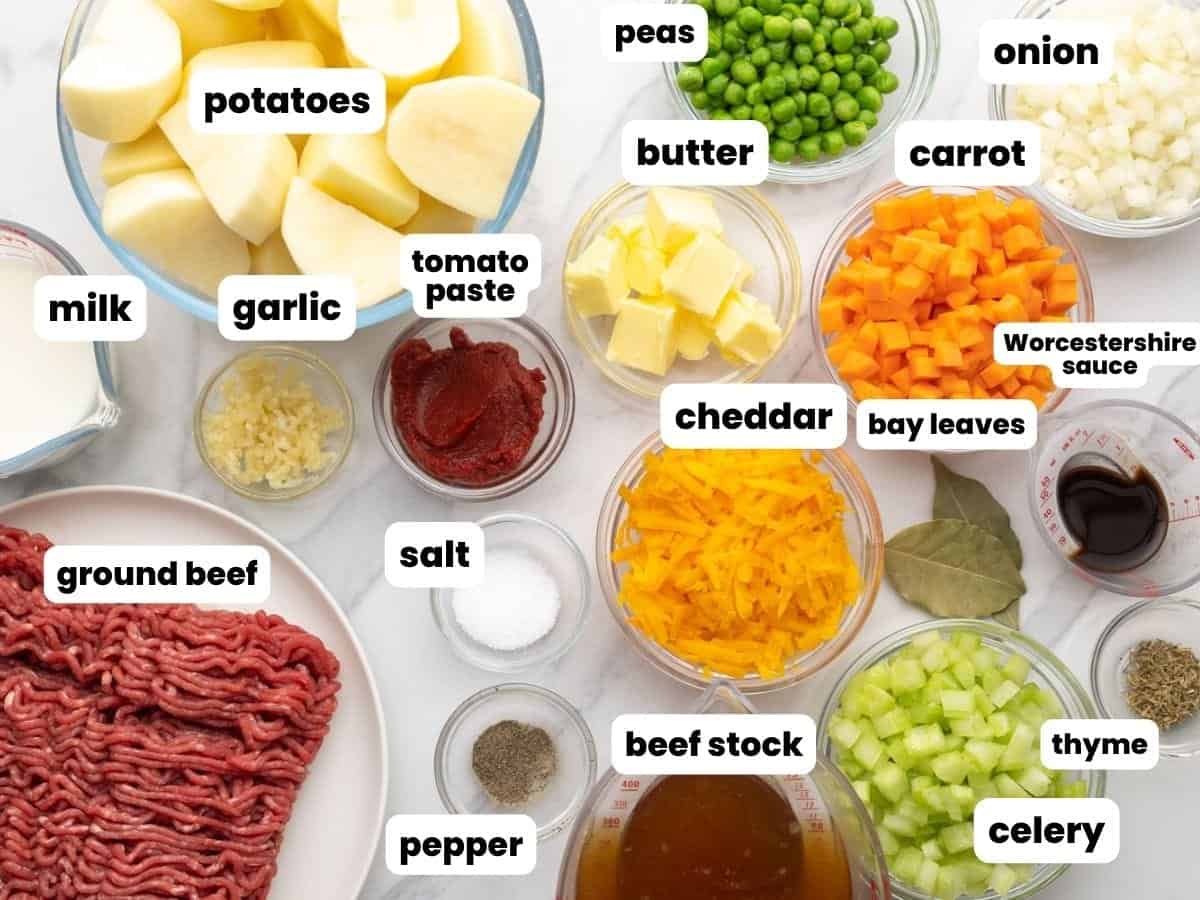 All of the ingredients needed to make a homemade cottage pie from scratch with ground beef, potatoes, and vegetables.